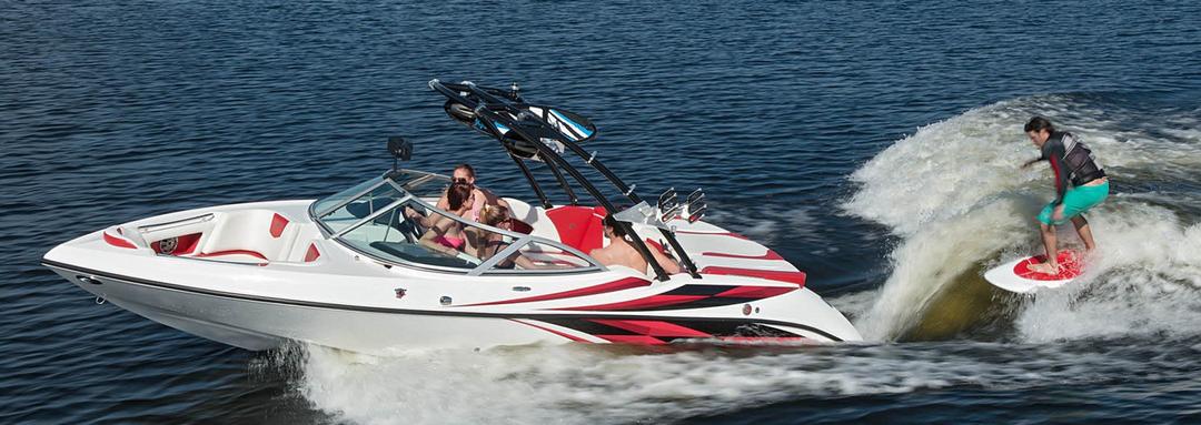 Family water skiing with a red speed boat rental at Lake Lewisville