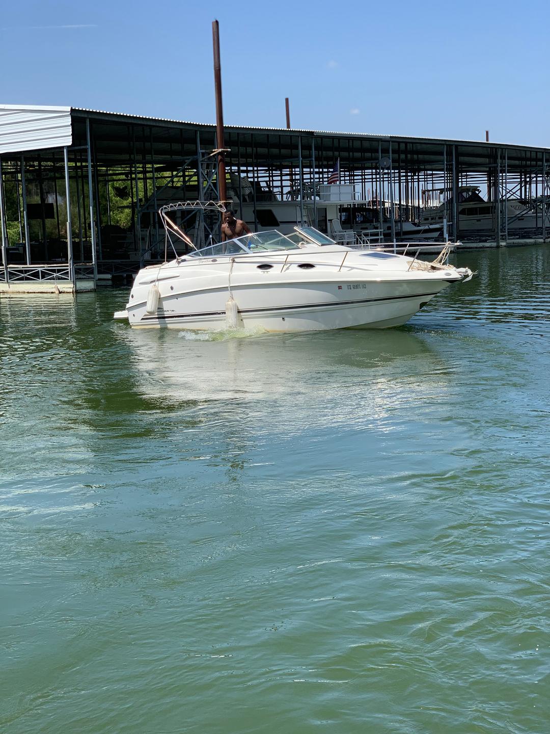 Customer leaving the dock in a white mini yacht cruiser boat rental at Lake Lewisville