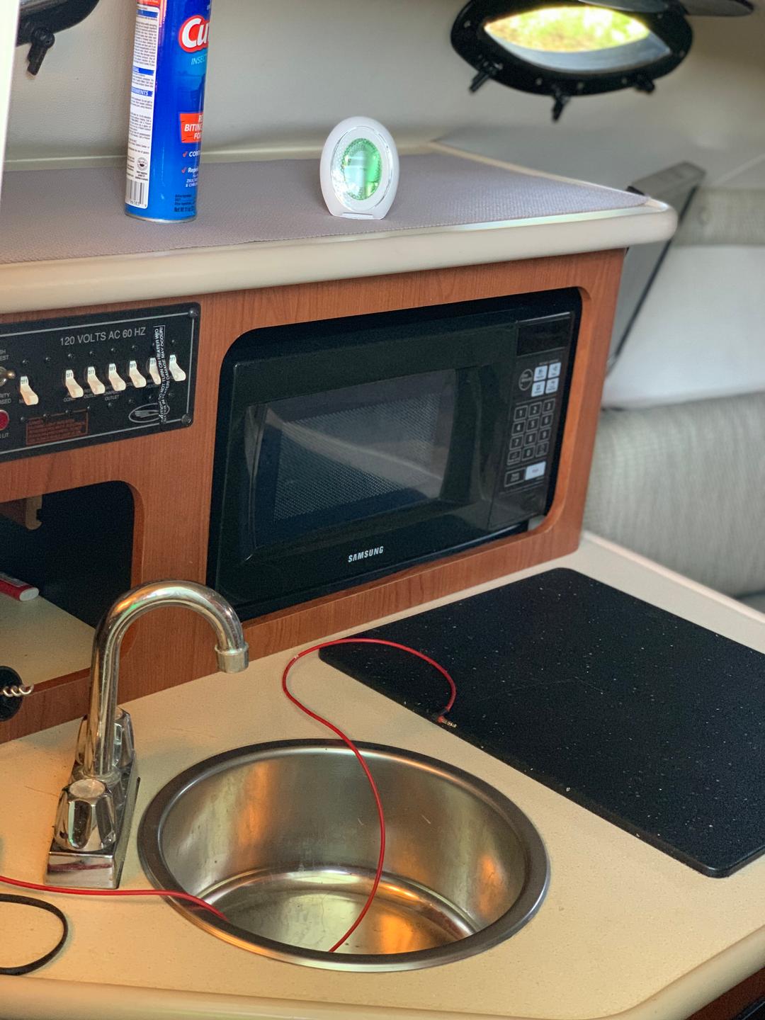 Microwave inside the white mini yacht cruiser boat rental at Lake Lewisville
