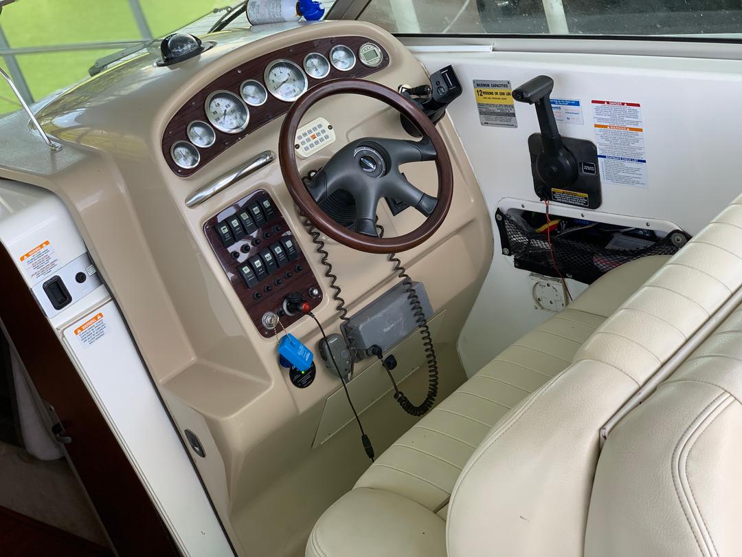 Driver's wheel inside the white mini yacht cruiser boat rental at Lake Lewisville